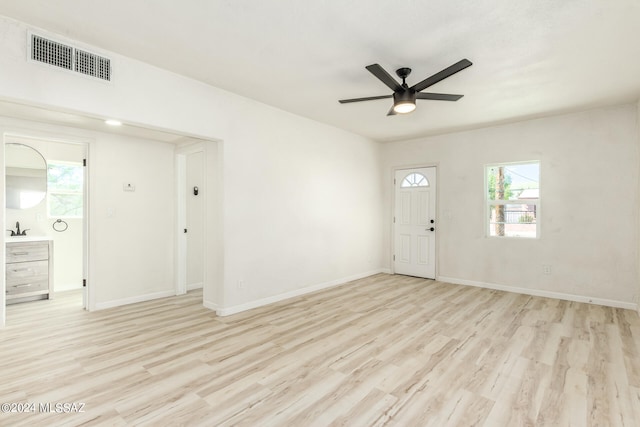 interior space with ceiling fan, light wood-type flooring, plenty of natural light, and sink