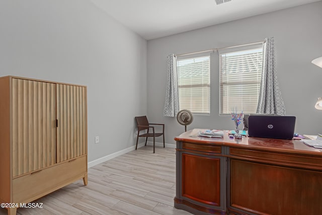 office with light hardwood / wood-style flooring