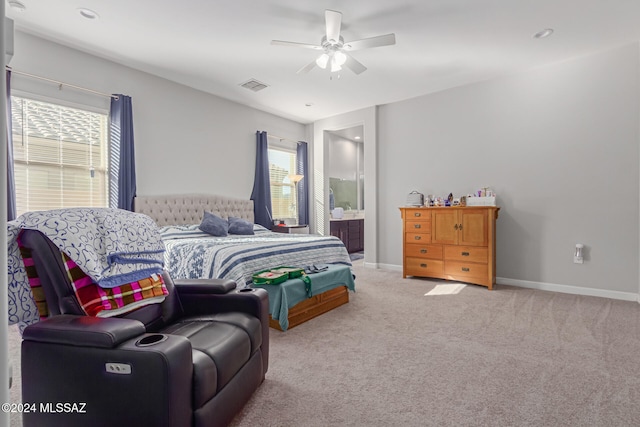 bedroom with connected bathroom, carpet, multiple windows, and ceiling fan