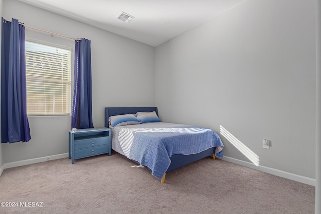 bedroom with light colored carpet