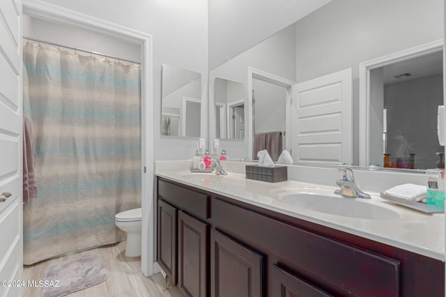 bathroom featuring toilet and vanity