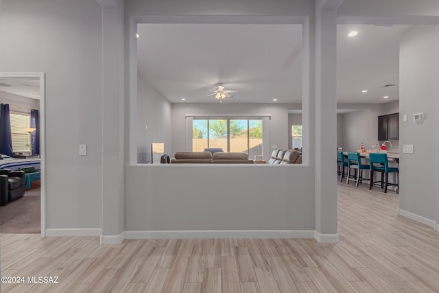 living room with ceiling fan and light hardwood / wood-style floors