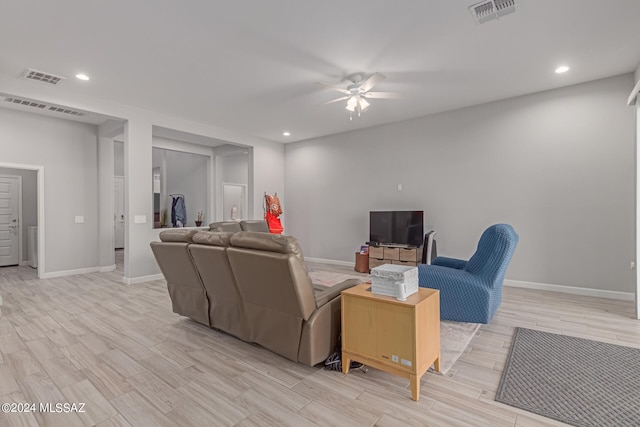 living room featuring light wood-type flooring and ceiling fan