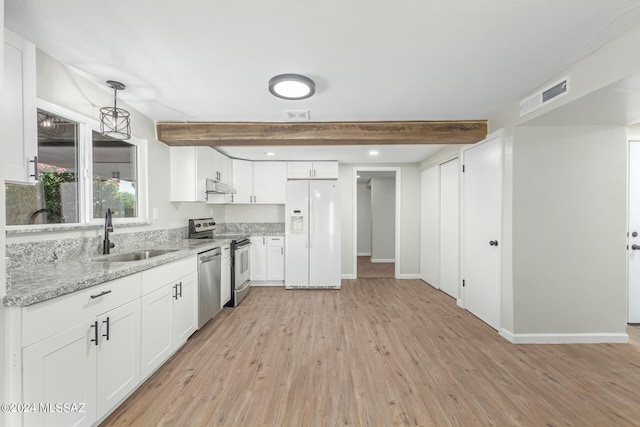 kitchen featuring pendant lighting, light hardwood / wood-style floors, stainless steel appliances, and white cabinets