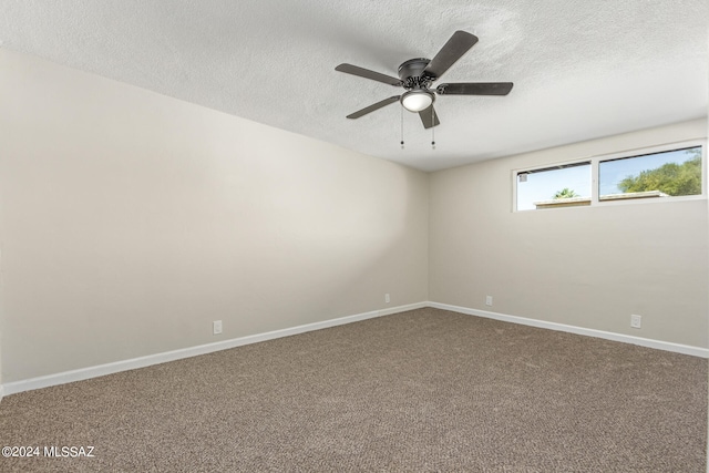 spare room featuring carpet floors, a textured ceiling, and ceiling fan