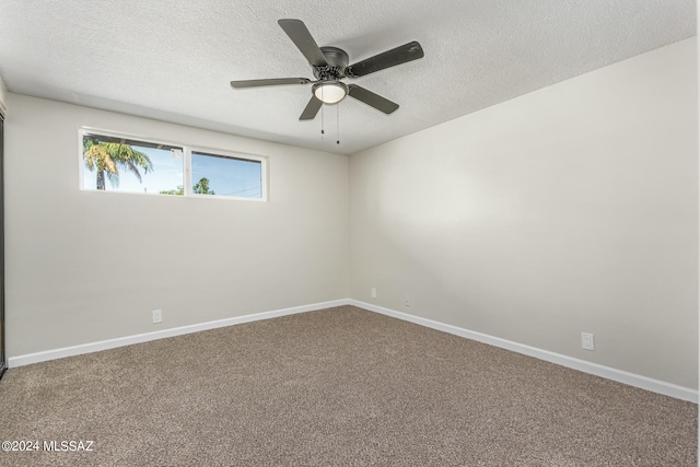 empty room featuring a textured ceiling, ceiling fan, and carpet flooring