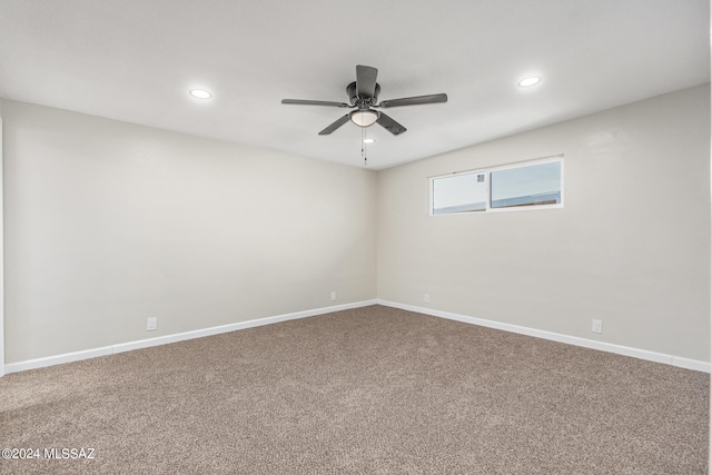 spare room featuring ceiling fan and carpet flooring