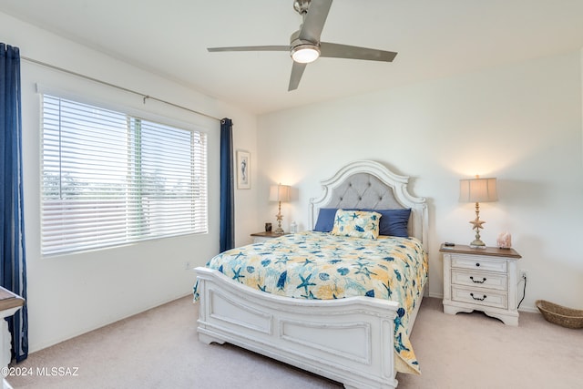 bedroom featuring ceiling fan and light carpet