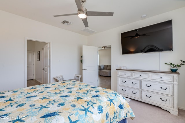 carpeted bedroom featuring connected bathroom and ceiling fan