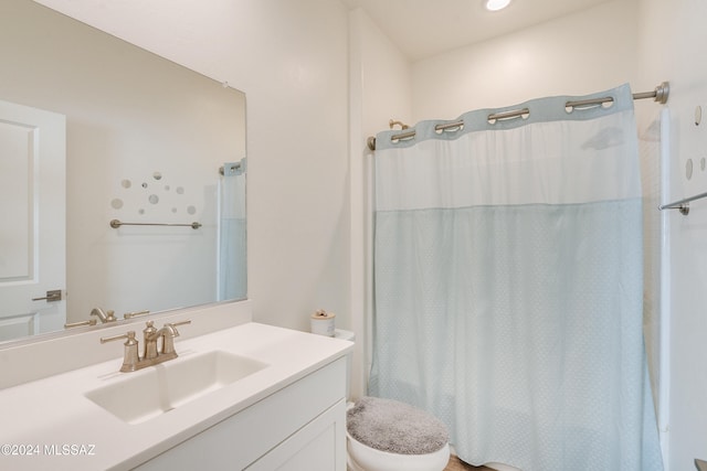 bathroom featuring vanity, a shower with shower curtain, and toilet