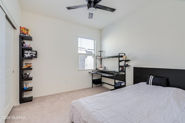 carpeted bedroom with a closet and ceiling fan