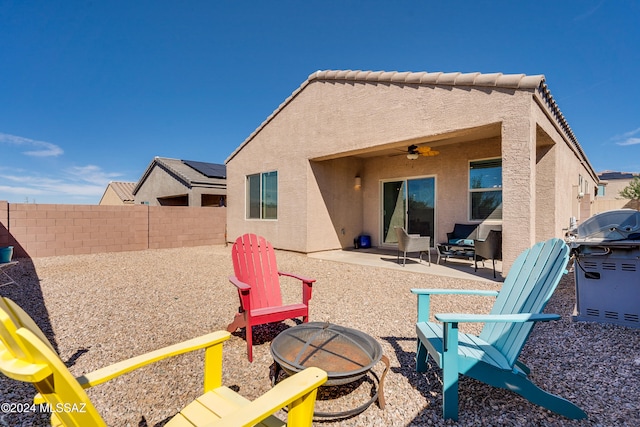 rear view of property with an outdoor fire pit, a patio, and ceiling fan