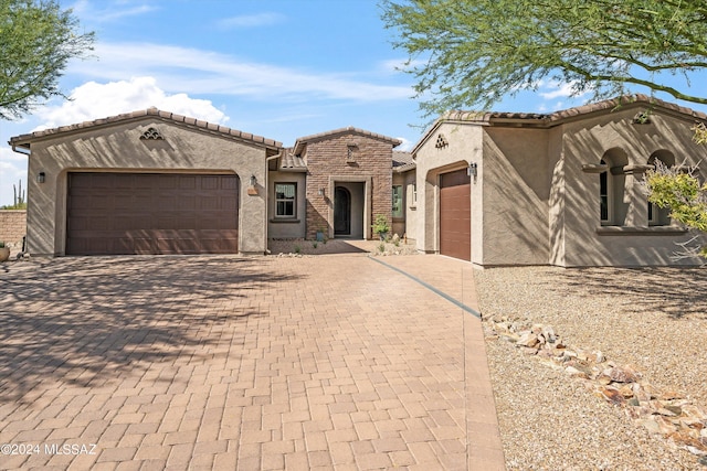 mediterranean / spanish-style home with a garage