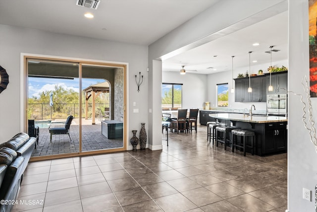 interior space featuring ceiling fan and dark tile patterned floors