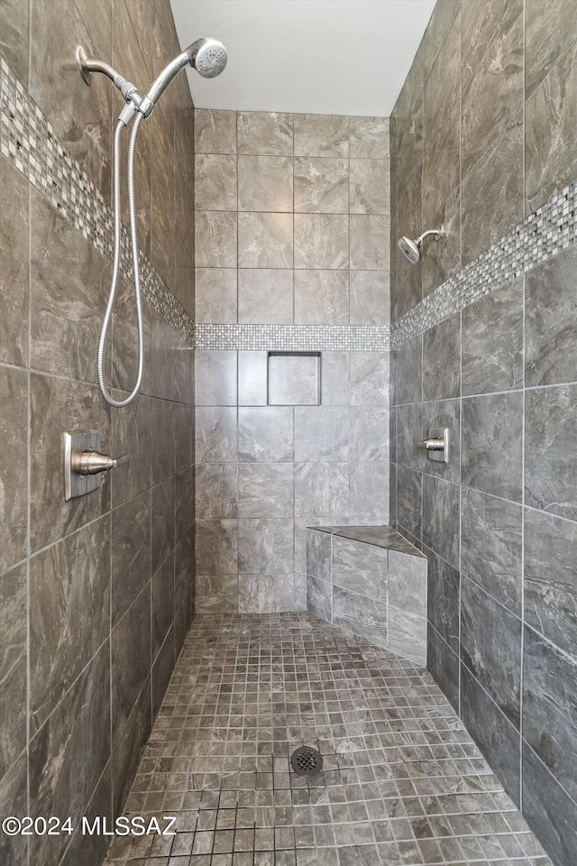 bathroom with tiled shower