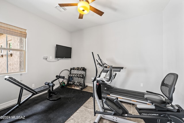 workout area with light tile patterned flooring and ceiling fan