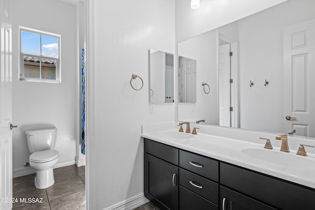 bathroom with vanity, toilet, and tile patterned floors