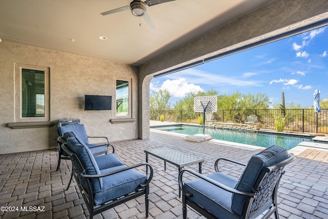 view of patio featuring a fenced in pool and ceiling fan