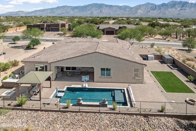 view of swimming pool featuring a patio and a mountain view