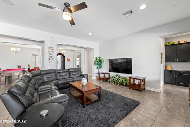 living room featuring billiards and ceiling fan with notable chandelier