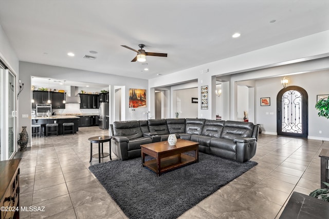 living room featuring ceiling fan and tile patterned floors