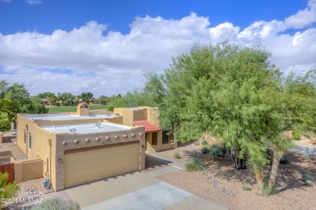 adobe home featuring a garage