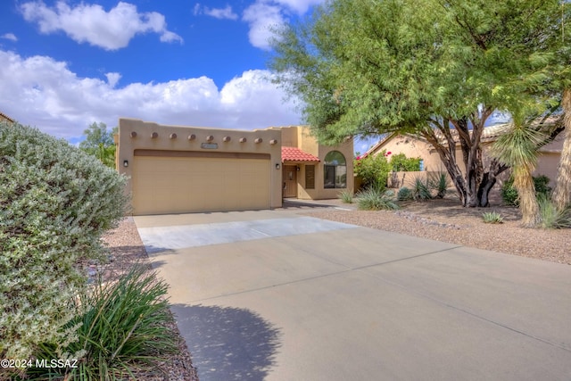 adobe home featuring a garage