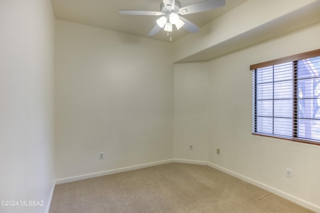 empty room featuring light carpet and ceiling fan