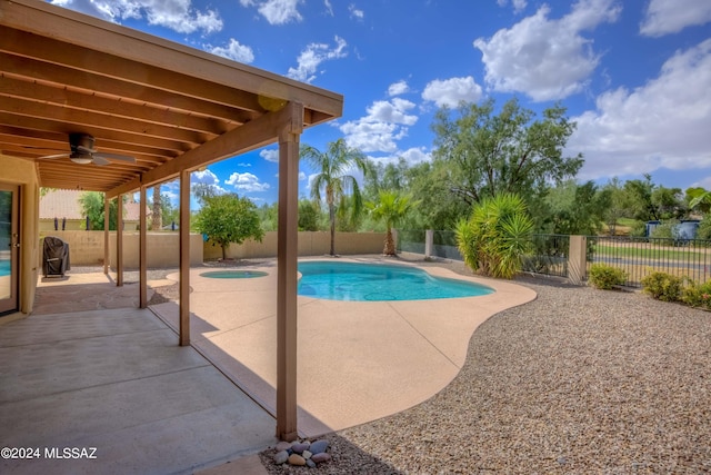 view of swimming pool featuring a patio and ceiling fan