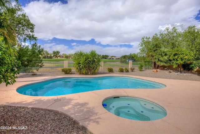 view of swimming pool with an in ground hot tub and a patio