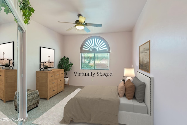 bedroom featuring light carpet and ceiling fan