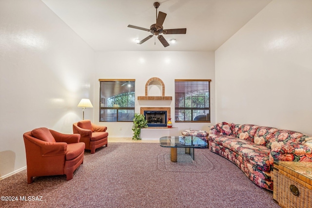 living room with ceiling fan, a tile fireplace, carpet, and a wealth of natural light