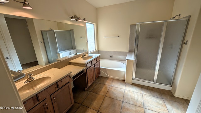 bathroom featuring vanity, independent shower and bath, and tile patterned floors