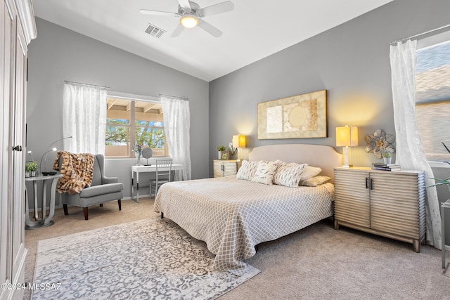 bedroom featuring ceiling fan, vaulted ceiling, and carpet