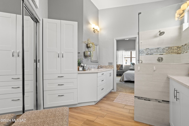 bathroom with vanity, hardwood / wood-style flooring, and walk in shower