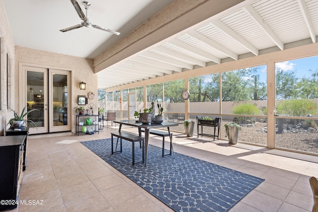 sunroom / solarium featuring ceiling fan, french doors, and beam ceiling