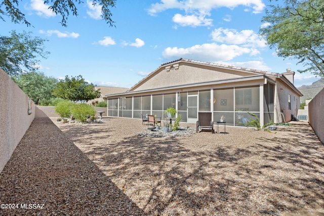 back of house featuring a sunroom