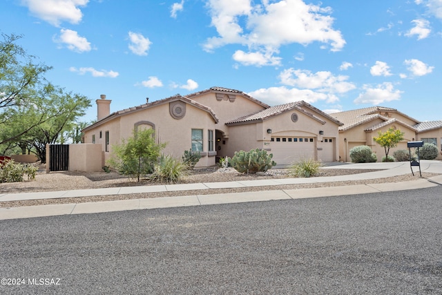 mediterranean / spanish-style home with a garage