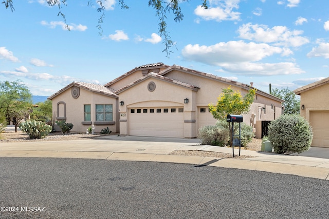 mediterranean / spanish-style home with a garage