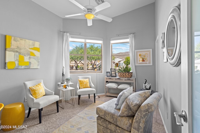 sitting room featuring light carpet and ceiling fan