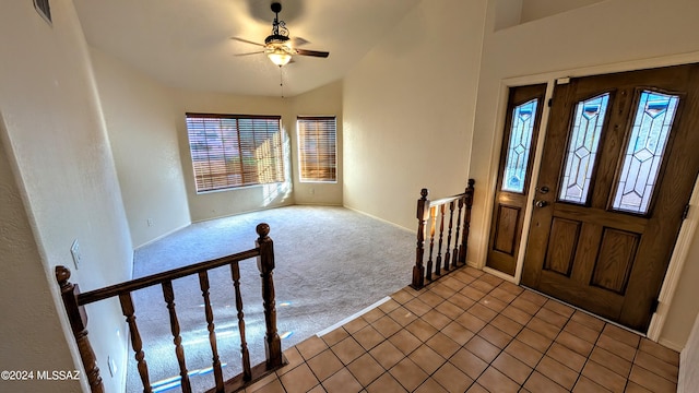 tiled foyer featuring lofted ceiling and ceiling fan