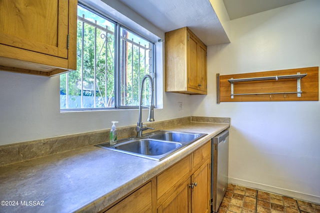 kitchen featuring stainless steel dishwasher and sink