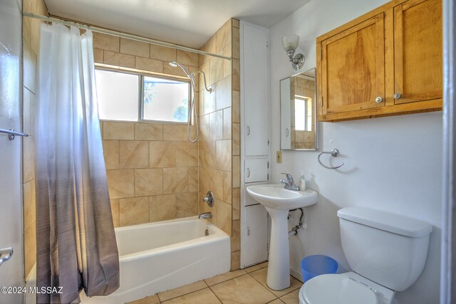 bathroom featuring toilet, tile patterned floors, and shower / tub combo with curtain