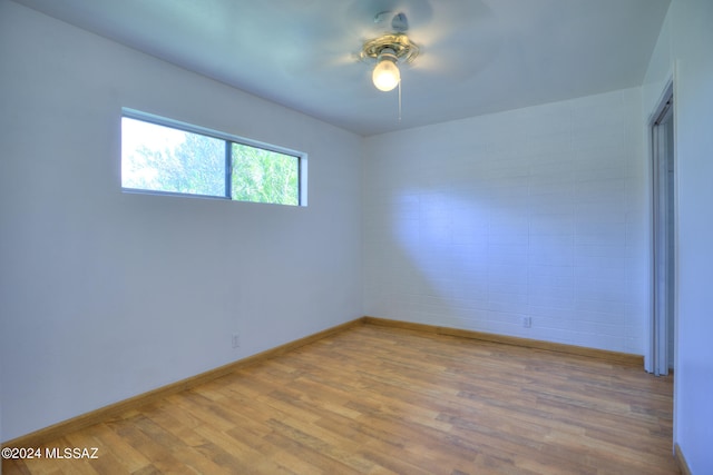 spare room with light hardwood / wood-style floors and ceiling fan