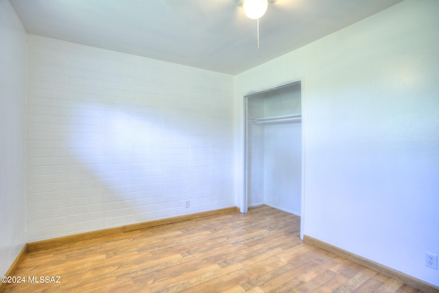 unfurnished bedroom featuring a closet and hardwood / wood-style floors