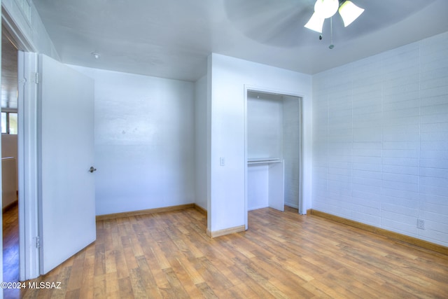 unfurnished bedroom featuring hardwood / wood-style flooring, a closet, and ceiling fan