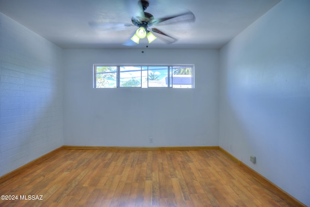 spare room with wood-type flooring and ceiling fan