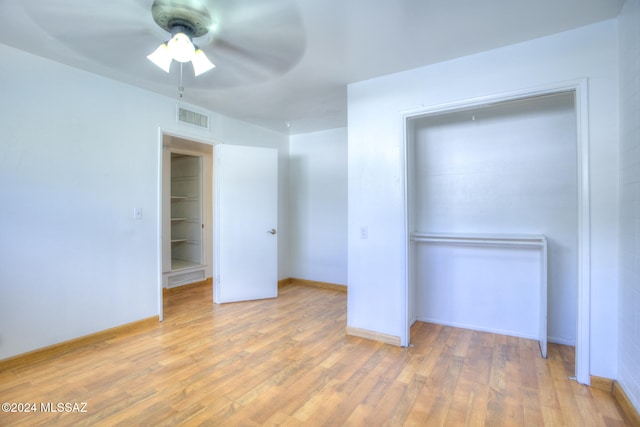 unfurnished bedroom featuring light hardwood / wood-style flooring, a closet, and ceiling fan