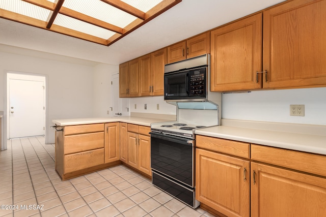 kitchen with kitchen peninsula, light tile patterned floors, a skylight, and electric stove