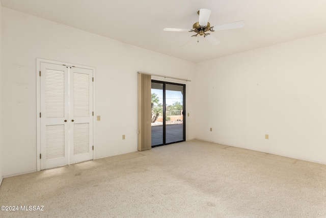 unfurnished bedroom with access to exterior, light colored carpet, and ceiling fan